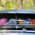 Rooftop cargo box loaded with gear (Yakima SkyBox 16 Carbonite)